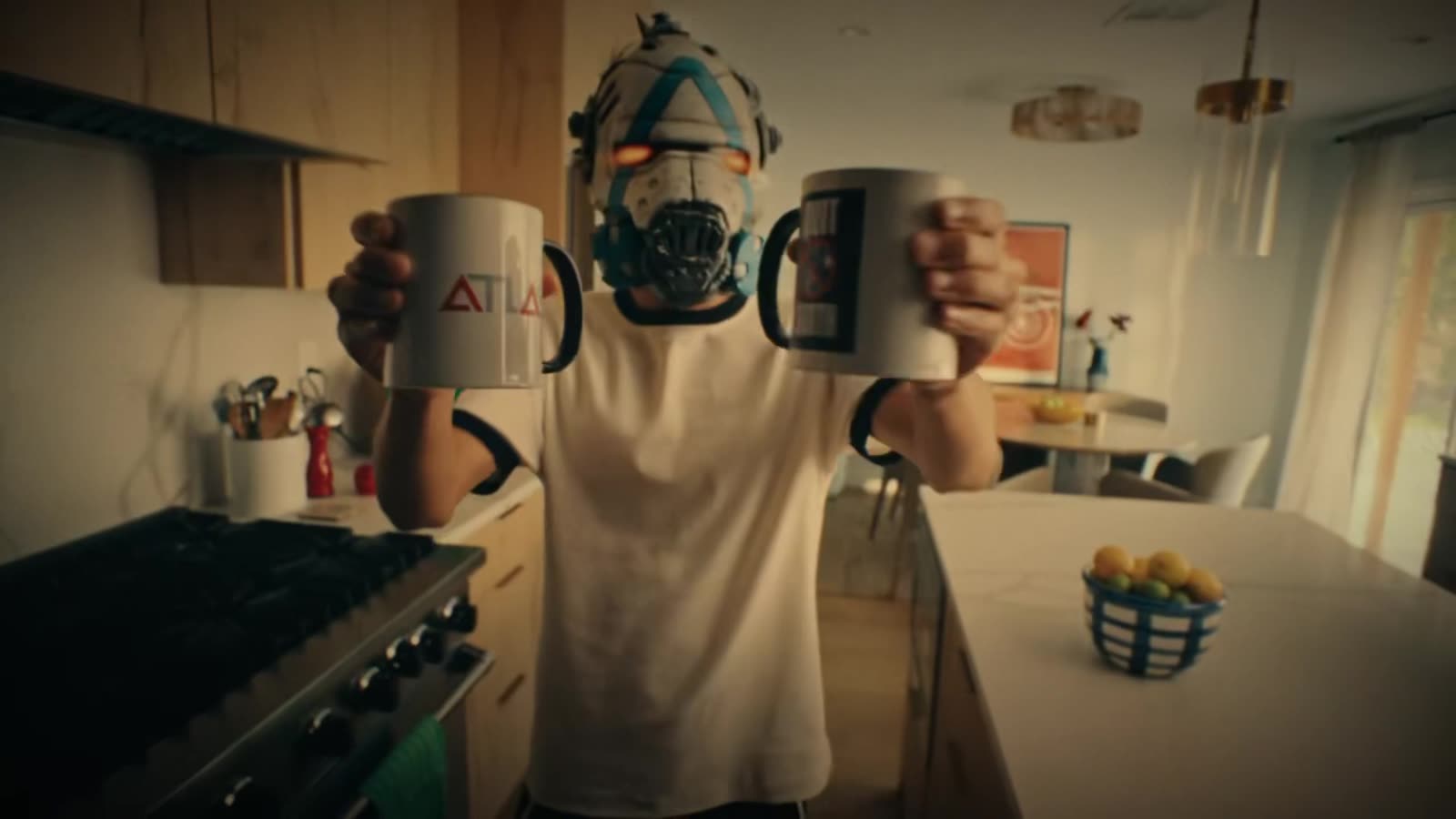 Masked player holding mugs in a kitchen