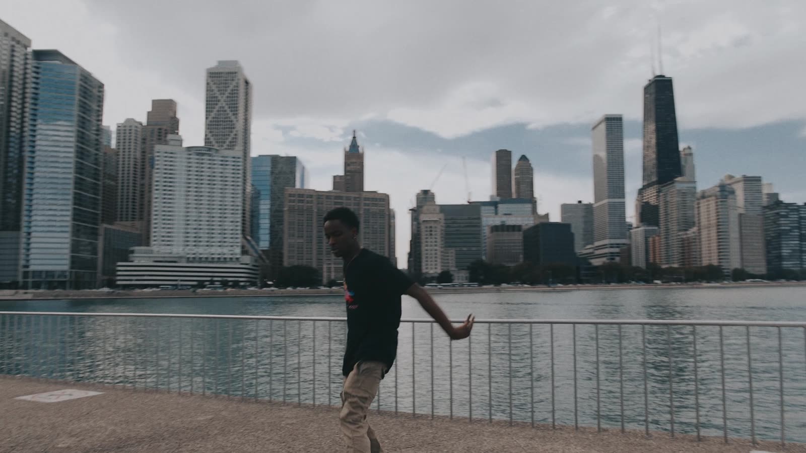 Footwork dancer on the lakefront with the skyline behind